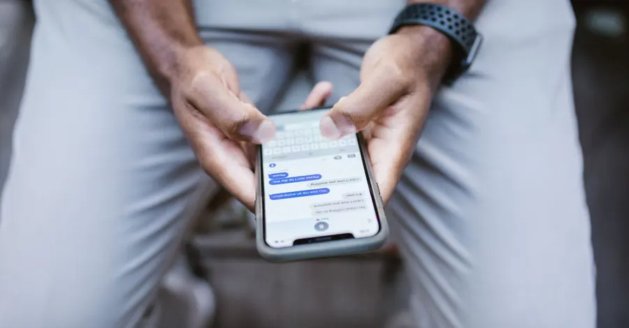 Un téléphone en main qui affiche une liste de demandes